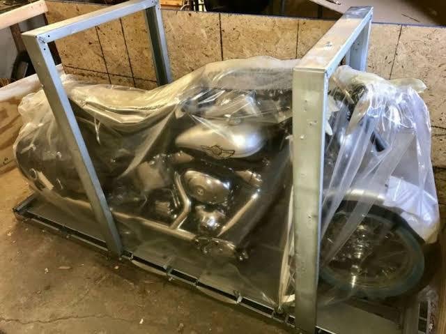 Motorcycle mounted in a custom steel crate frame for safe transport