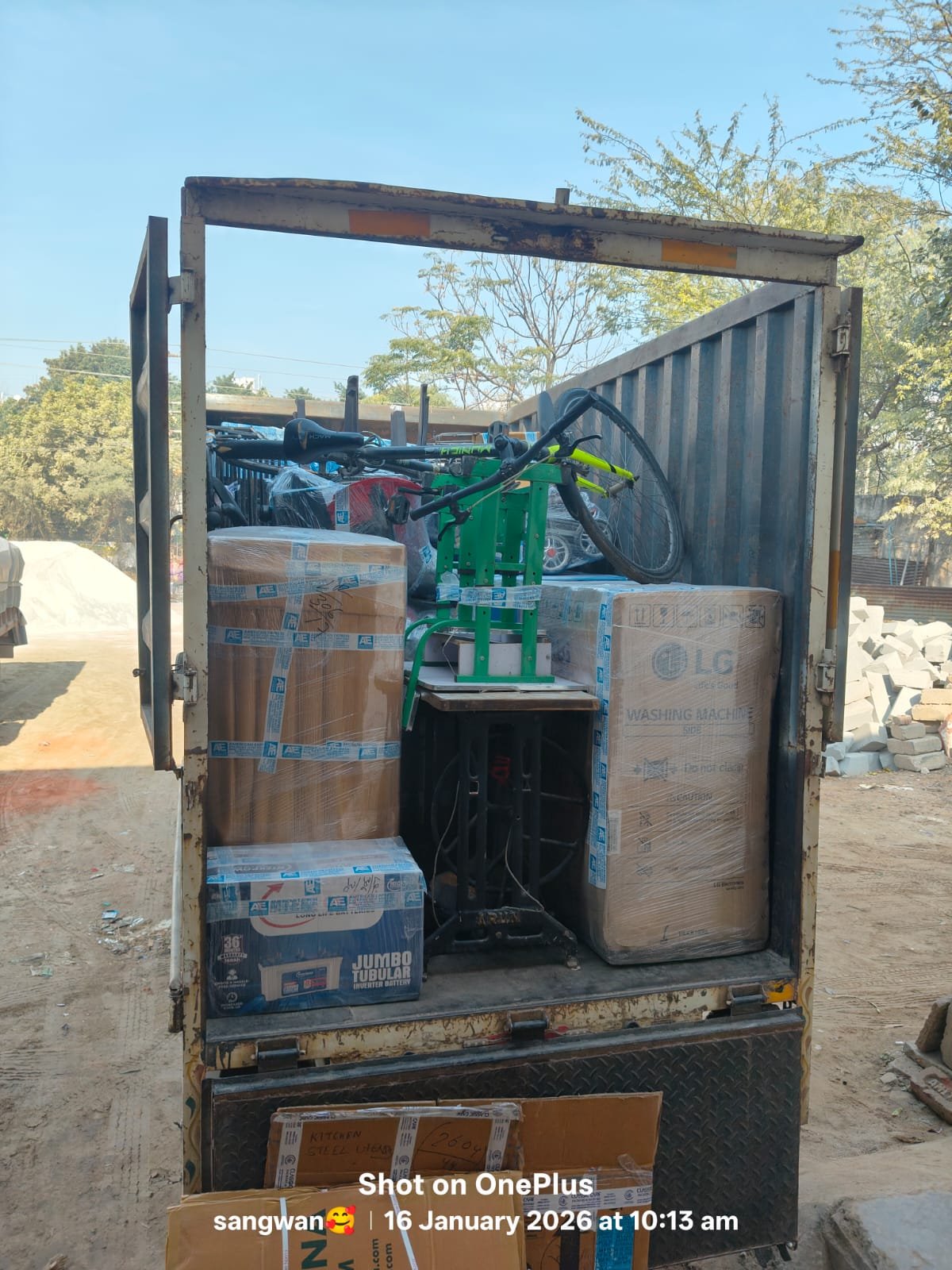Moving crew loading packed boxes into a container with lifting equipment
