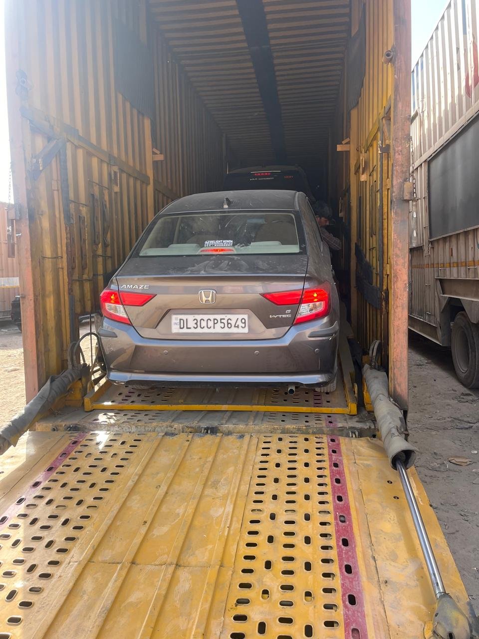 Sedan loaded and lashed inside a covered car carrier