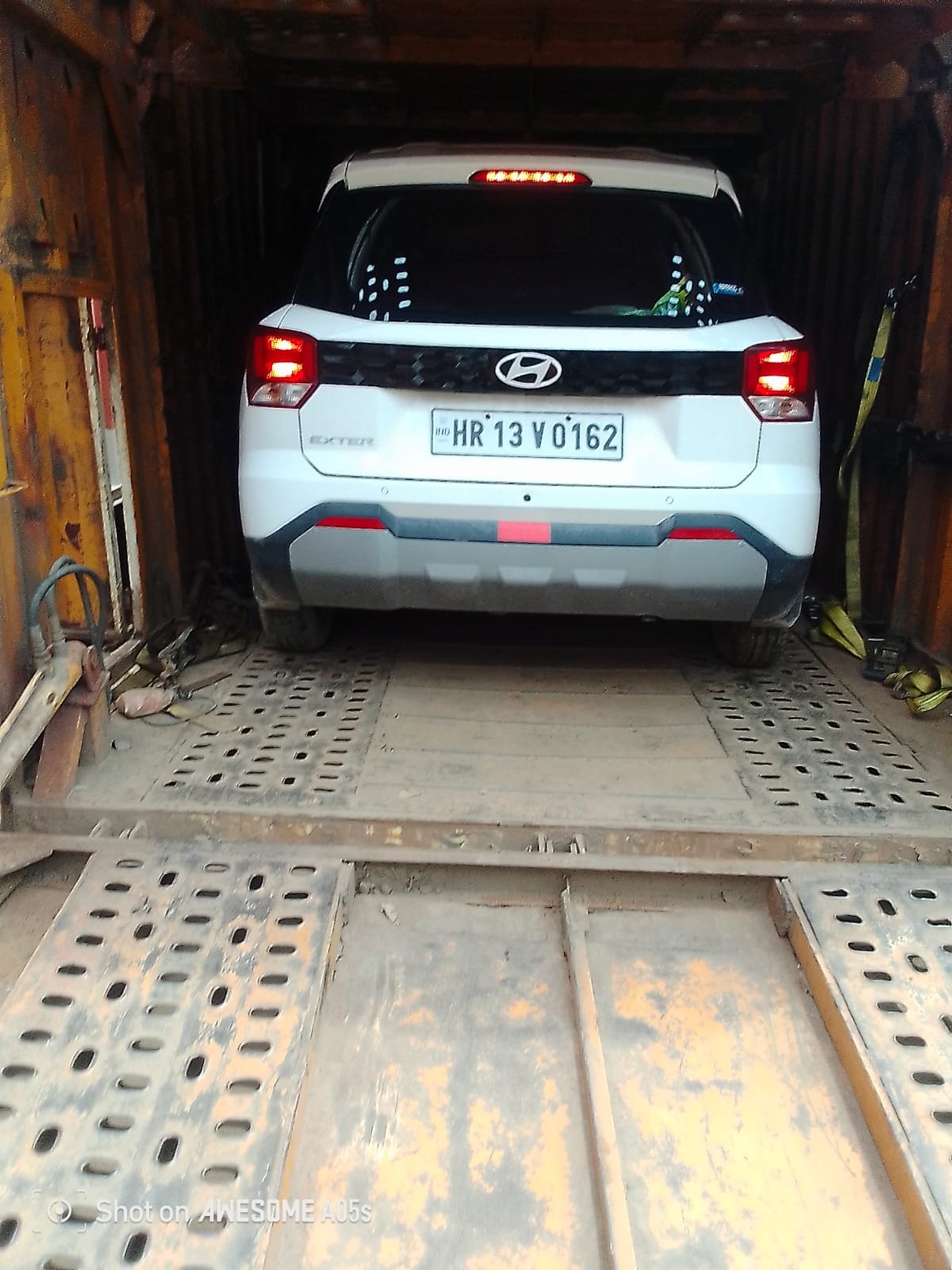 Hyundai car being loaded onto a hydraulic car carrier ramp