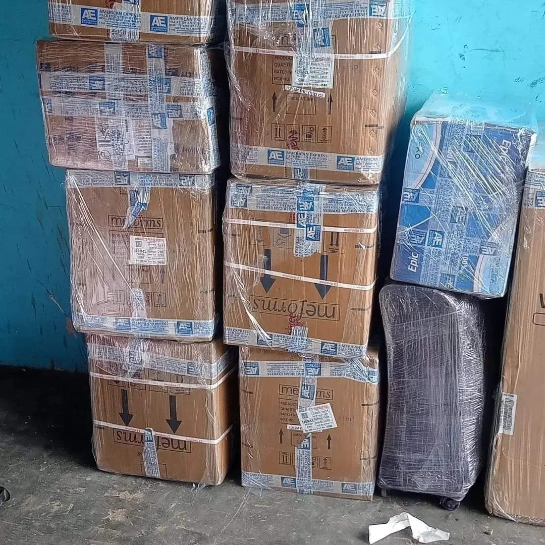 Cartons wrapped in protective plastic film stacked and ready for transport